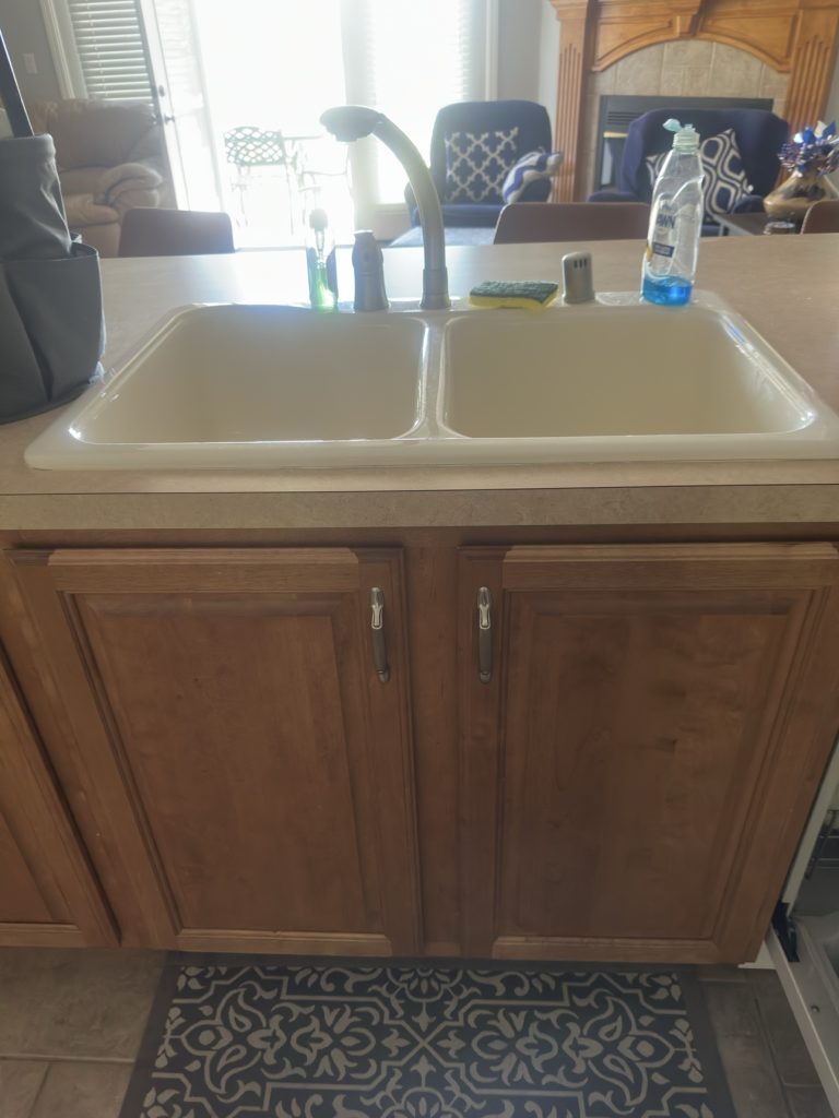 Spotless kitchen sink with wooden cabinets
