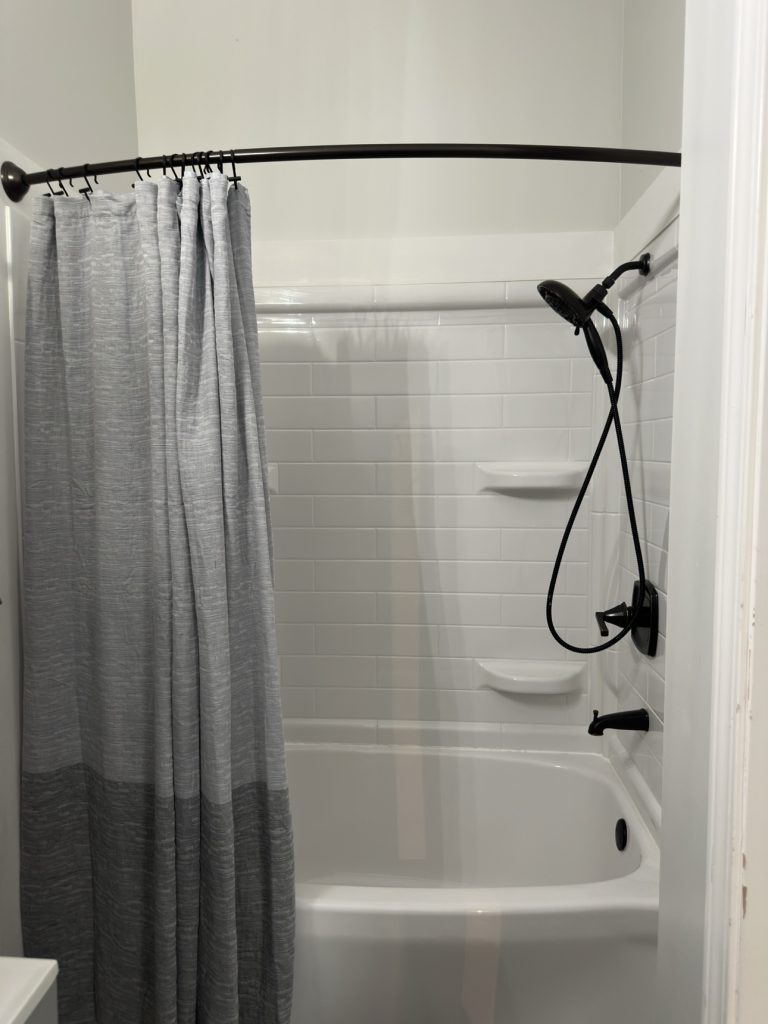 Freshly cleaned bathroom with tub and shower