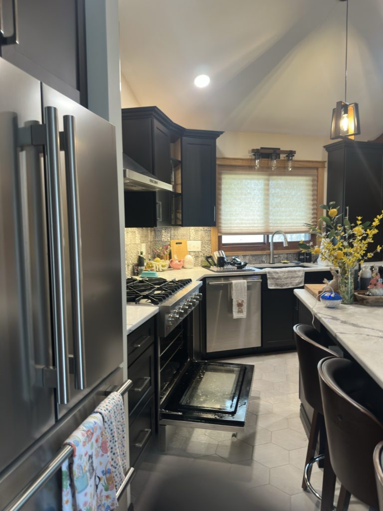 Spotless modern kitchen with black cabinets after a deep clean