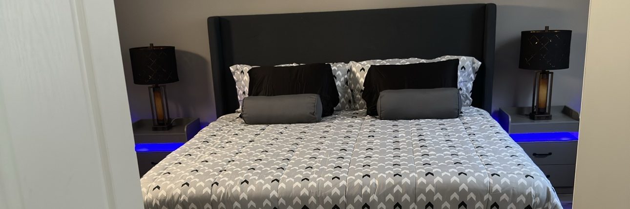 Freshly cleaned bedroom with made bed