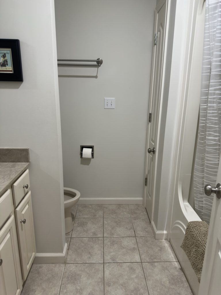 Compact bathroom with vanity and shower after cleaning