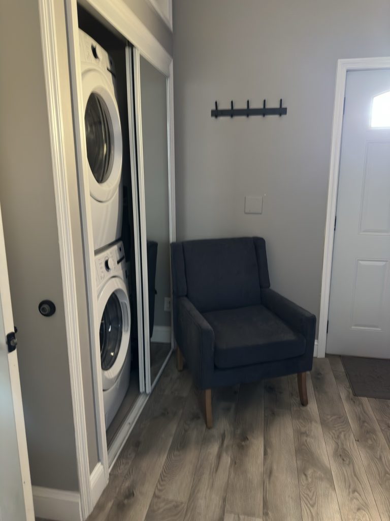 Tidy laundry nook with stacked washer and dryer